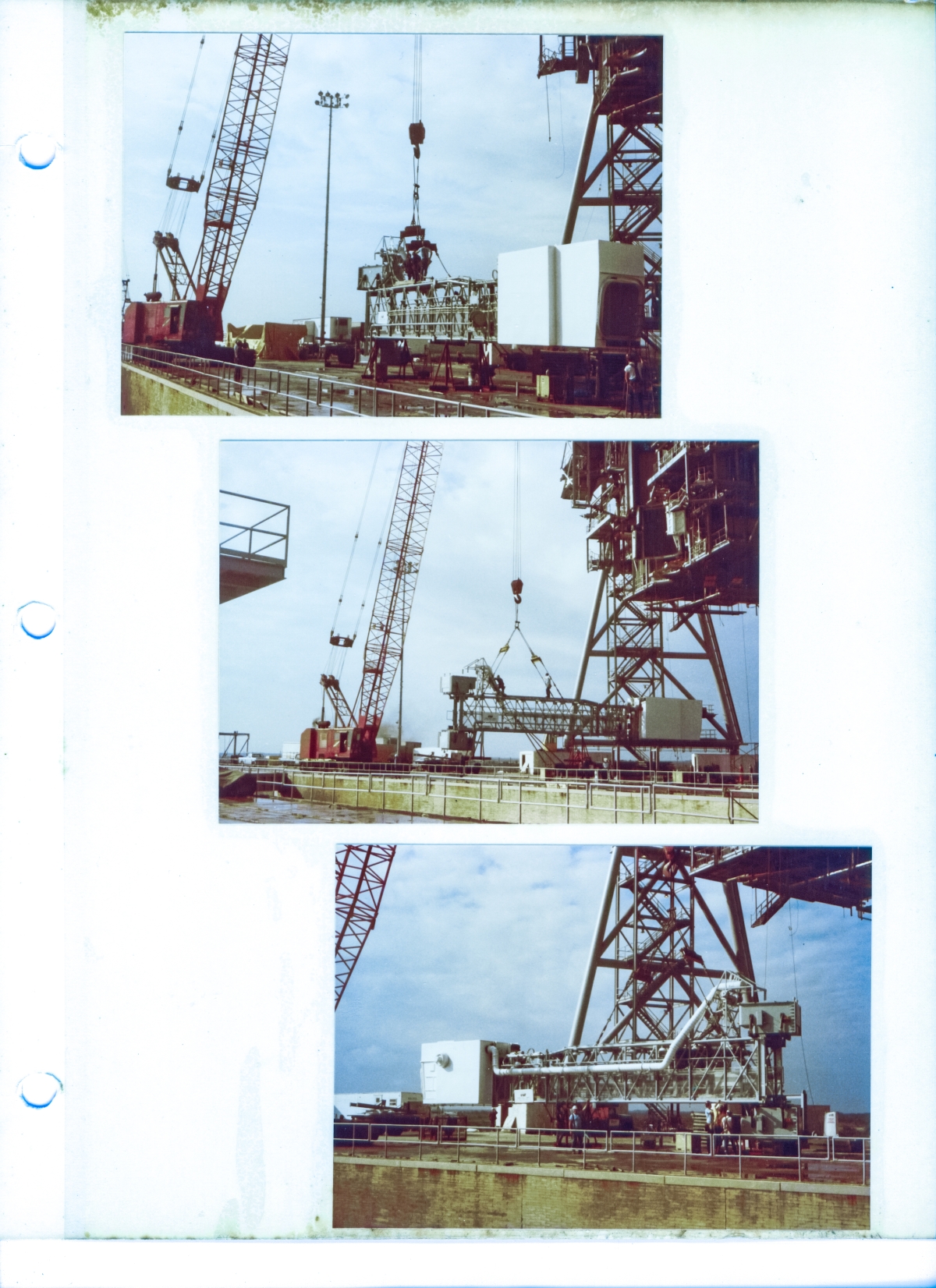 The Orbiter Access Arm (Crew Access Arm) is rigged and then lifted slightly and repositioned for final inspection and rigging adjustments prior to being lifted and attached to the Fixed Service Structure at the 200-foot elevation, by union ironworkers working for Ivey Steel at Space Shuttle Launch Complex 39-B, Kennedy Space Center, Florida.